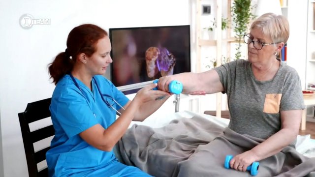 Nurse holds a woman's arm.