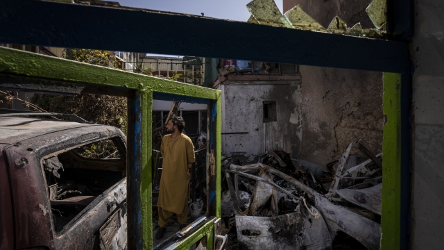 An Afghan inspects the damage of Ahmadi family house in Kabul, Afghanistan