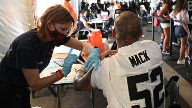 Mel Ondik gives a COVID-19 vaccine to Joseph Garduno before the Raiders-Ravens Monday Night Football game on Sept. 13.