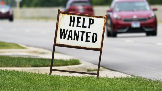 A help-wanted sign is displayed at a gas station in Mount Prospect, Ill.