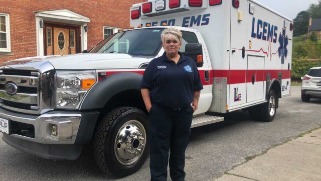 A paramedic stands by an ambulance.