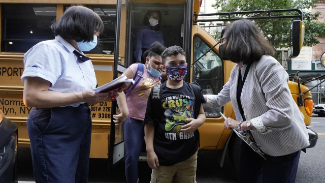 Students greeted as they arrive to school in New York City.