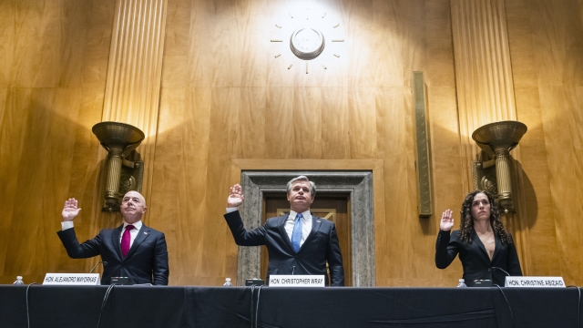 Alejandro Mayorkas, left, Christopher Wray, center, and Christine Abizaid, right, are sworn-in prior to testifying