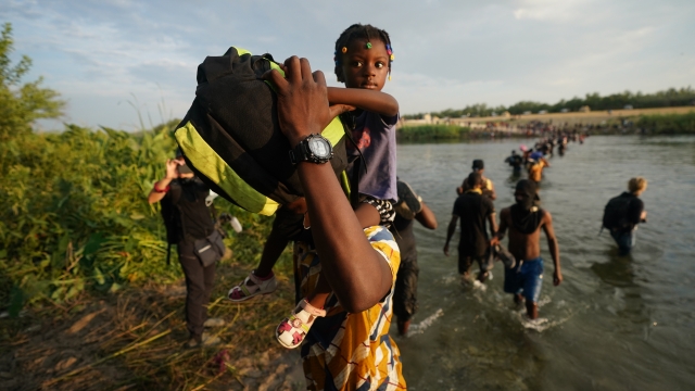 Migrants, many from Haiti, cross the Rio Grande from Del Rio, Texas, to return to Ciudad Acuna, Mexico