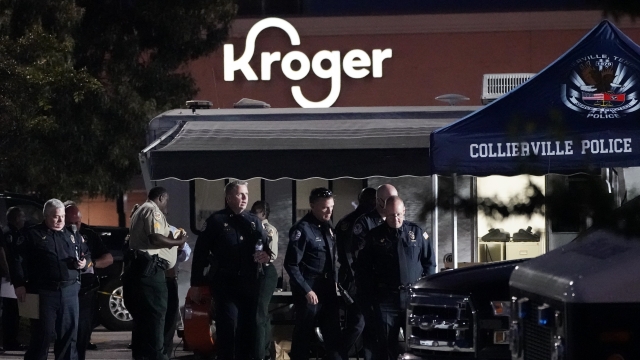 Law enforcement personnel work the scene of a shooting at a Tennessee Kroger store.