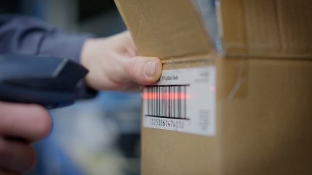 Warehouse worker scans a package.