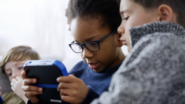 Kids watch videos on a handheld device