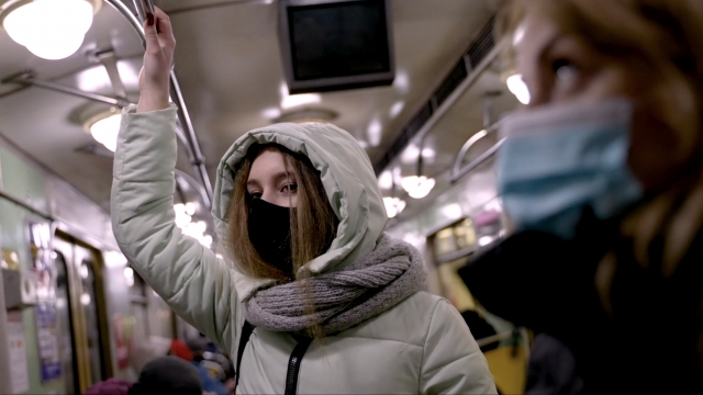 People wear masks on public transit.