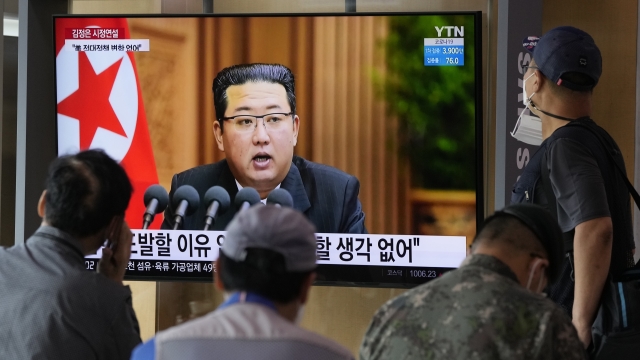 People watch a TV screen showing North Korean leader Kim Jong Un.