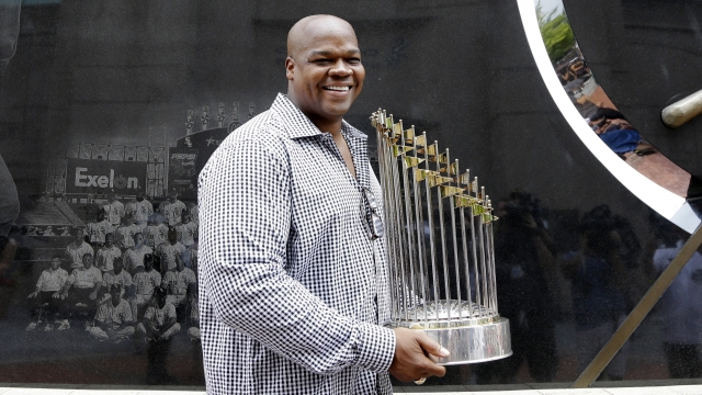 Former Chicago White Sox player and Hall of Famer Frank Thomas holds the 2005 World Series Champion trophy.