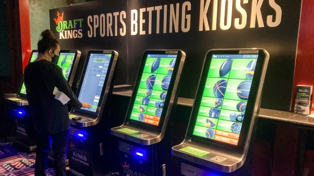 A man places a bet at one of the new sports wagering kiosks