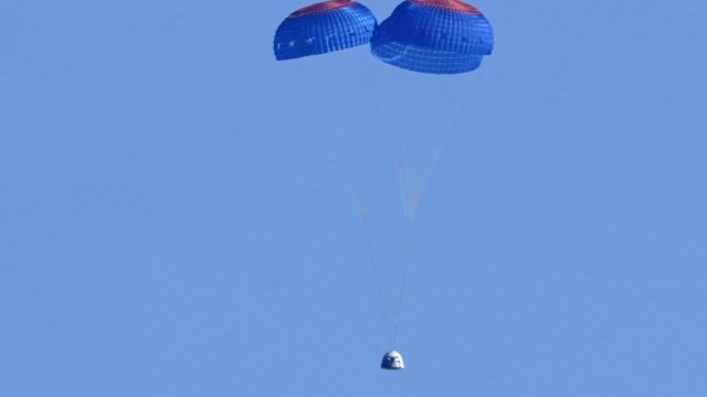 Parachutes slow the descent of the Blue Origin capsule