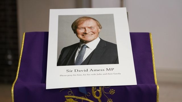 An image of murdered British Conservative lawmaker David Amess is displayed near the altar in St. Peter's Catholic Church