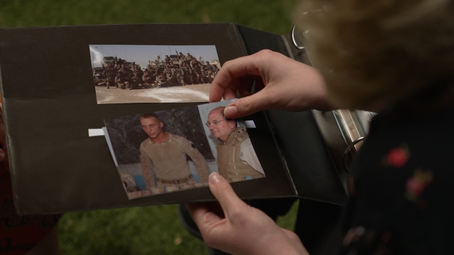 A person looks at photographs in an album
