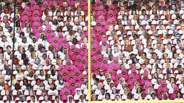 Washington Football Team fan cutouts form a Breast Cancer Awareness Ribbon during an NFL game