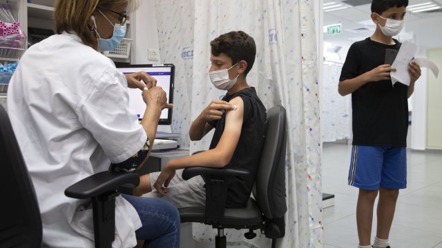 a youth receives a Pfizer-BioNTech COVID-19 vaccine