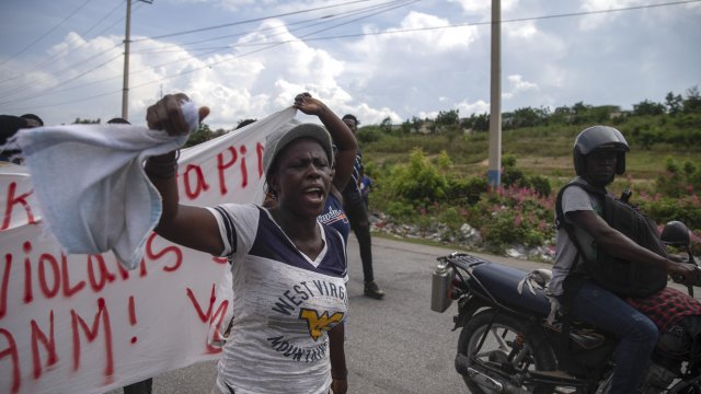 People protest for the release of the kidnapped missionaries near the missionaries' headquarters in Titanyen