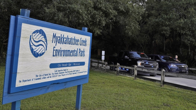 Florida police officers block the entrance to the Myakkahatchee Creek Environmental Park.