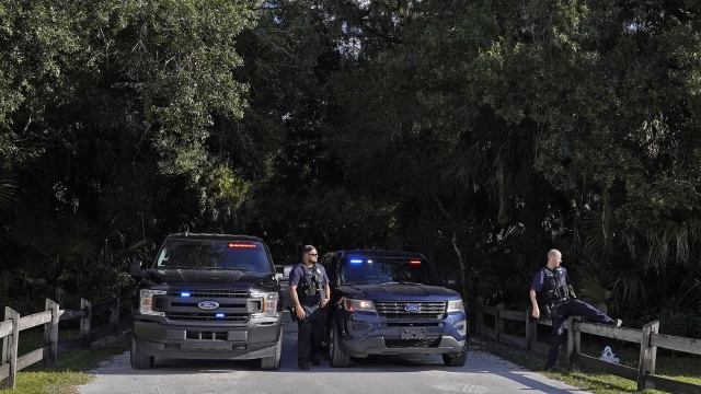 North Port police officers block the entrance to the Myakkahatchee Creek Environmental Park