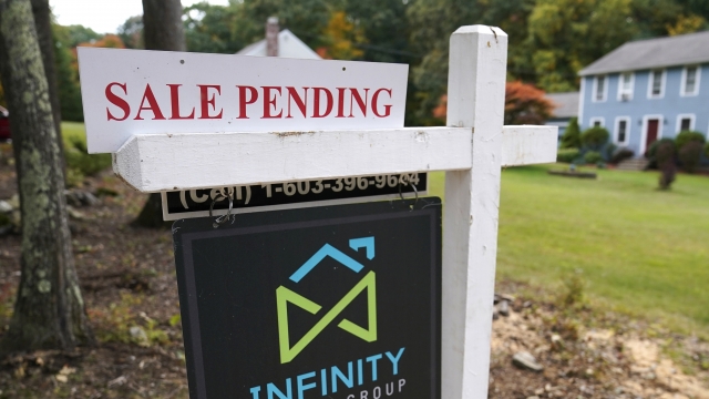 A "sale pending" sign in front of a home.