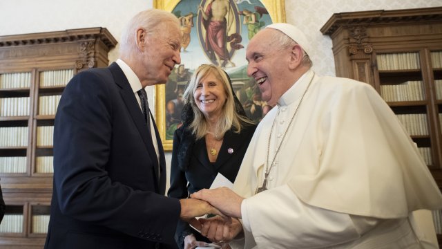 U.S. President Joe Biden shakes hands with Pope Francis as they meet at the Vatican.