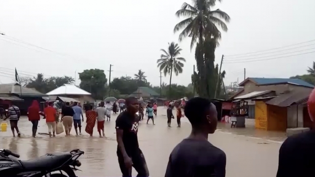 Dar es Salaam residents walk through flood waters