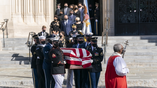 The flag-draped casket of former Secretary of State Colin Powell is carried from the Washington National Cathedral