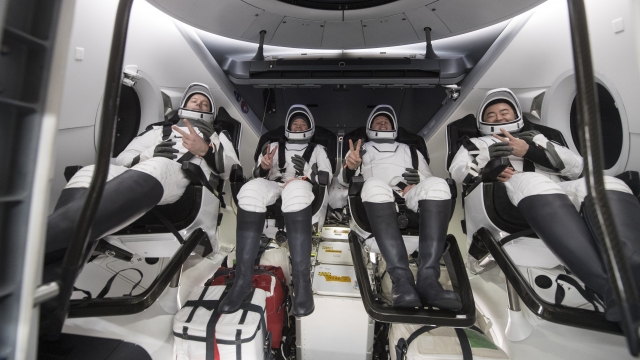 Astronauts inside the SpaceX Dragon spacecraft.
