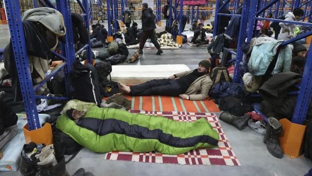 Migrants settle for the night in the logistics center in the checkpoint "Kuznitsa" at the Belarus-Poland border.