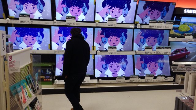 A shopper looks at televisions for sale.