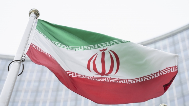 The flag of Iran waves in front of the International Center building at the International Atomic Energy Agency in Austria.