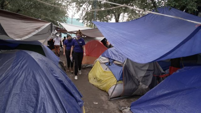 Women walk through a refugee camp in Mexico near the U.S. border.