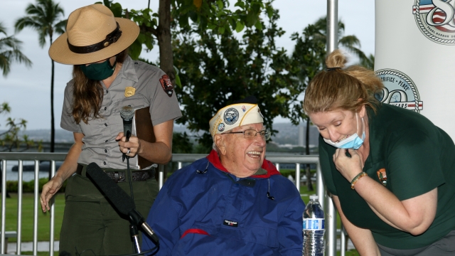 Pearl Harbor survivor Herb Elfring speaks with National Park Service workers in Pearl Harbor, Hawaii