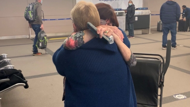 Two women hug at Denver International Airport