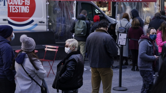 People wait in line at a COVID-19 testing site in Times Square, New York, Dec. 13, 2021.