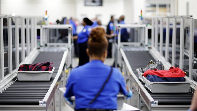 TSA looks through baggage at an airport.