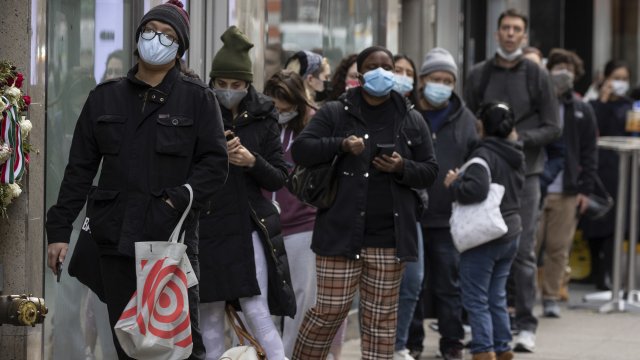 Masked people line the streets in New York.