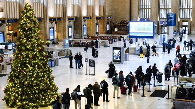 Passengers wait in line to board an Amtrak train ahead of the Thanksgiving Day