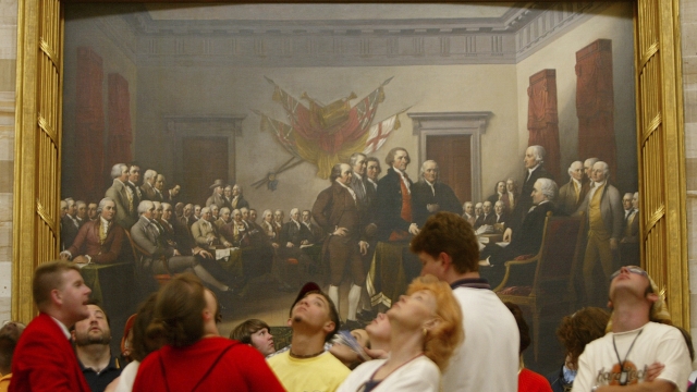 Visitors tour the Capitol Rotunda near John Trumbull's painting titled "Declaration of Independence, July 4th, 1776."