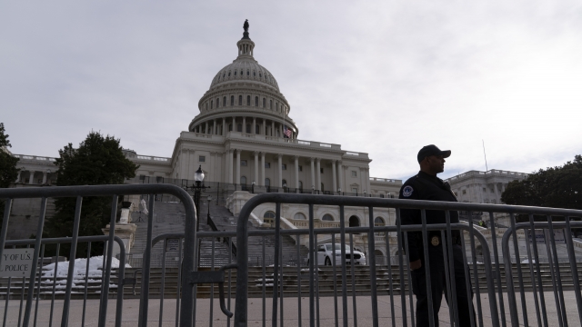 A U.S. Capitol Police officer scans the area on the first anniversary of the Jan. 6 U.S. Capitol insurrection