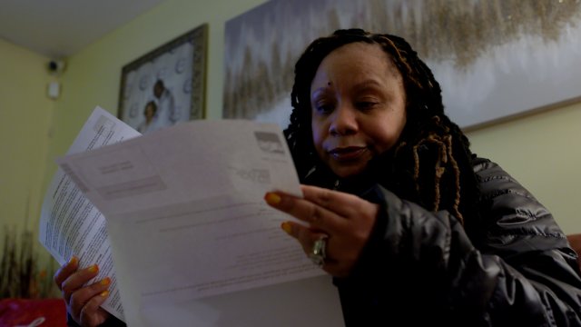 A woman looks at her loan statements.