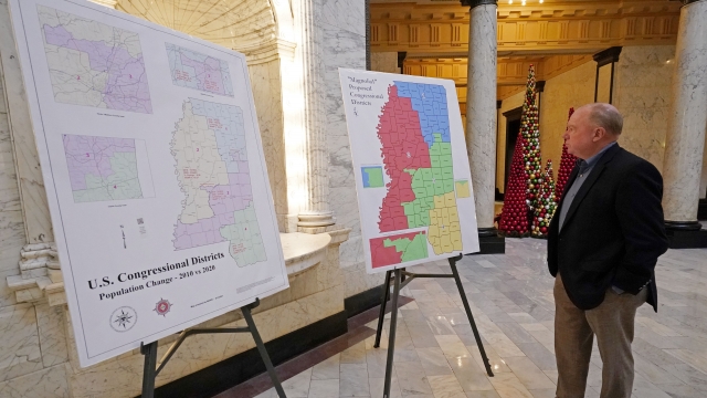 Richard Brown studies current, left, and proposed congressional boundaries plans