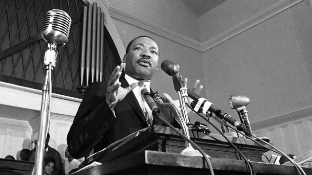 Martin Luther King Jr. talks at a podium.