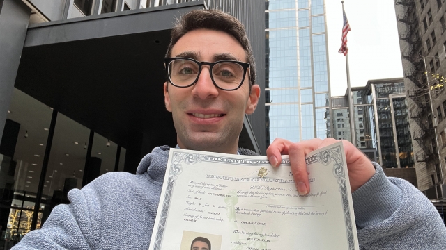 Newsy's Ben Schamisso stands with his citizenship document.