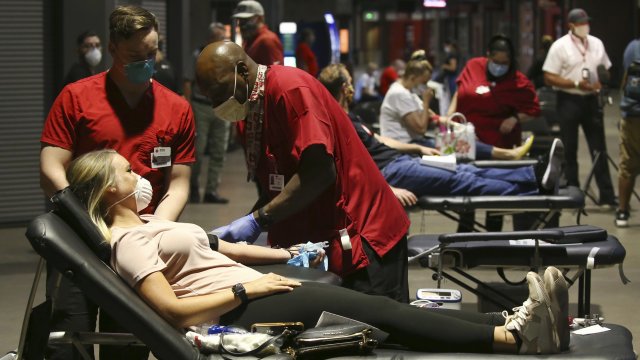 People donate blood during a Red Cross blood drive.