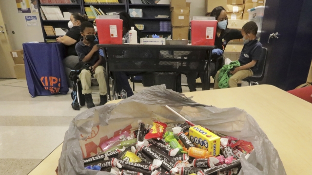 Bag of candy rewards students for their bravery as medical personnel vaccinate students at KIPP Believe Charter
