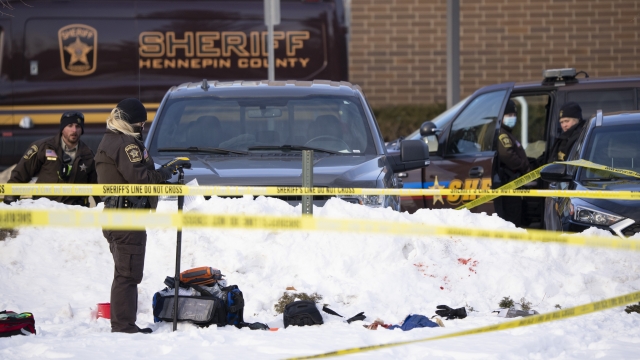 Investigators from Hennepin County Sheriff's Office process the scene of a shooting
