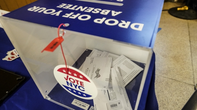 Absentee ballots are seen in a sealed ballot box