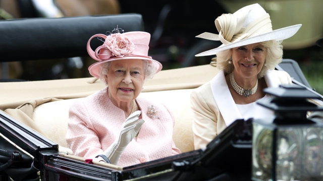 Britain's Queen Elizabeth II waves to the crowds with Camilla, Duchess of Cornwall