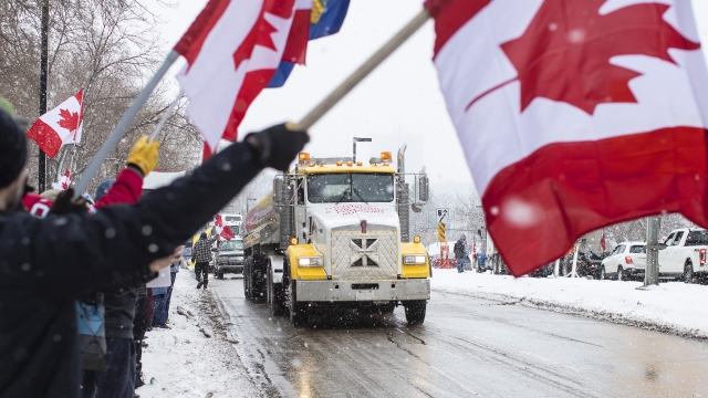 People along the street and truckers protest Canada's COVID-19 mandates